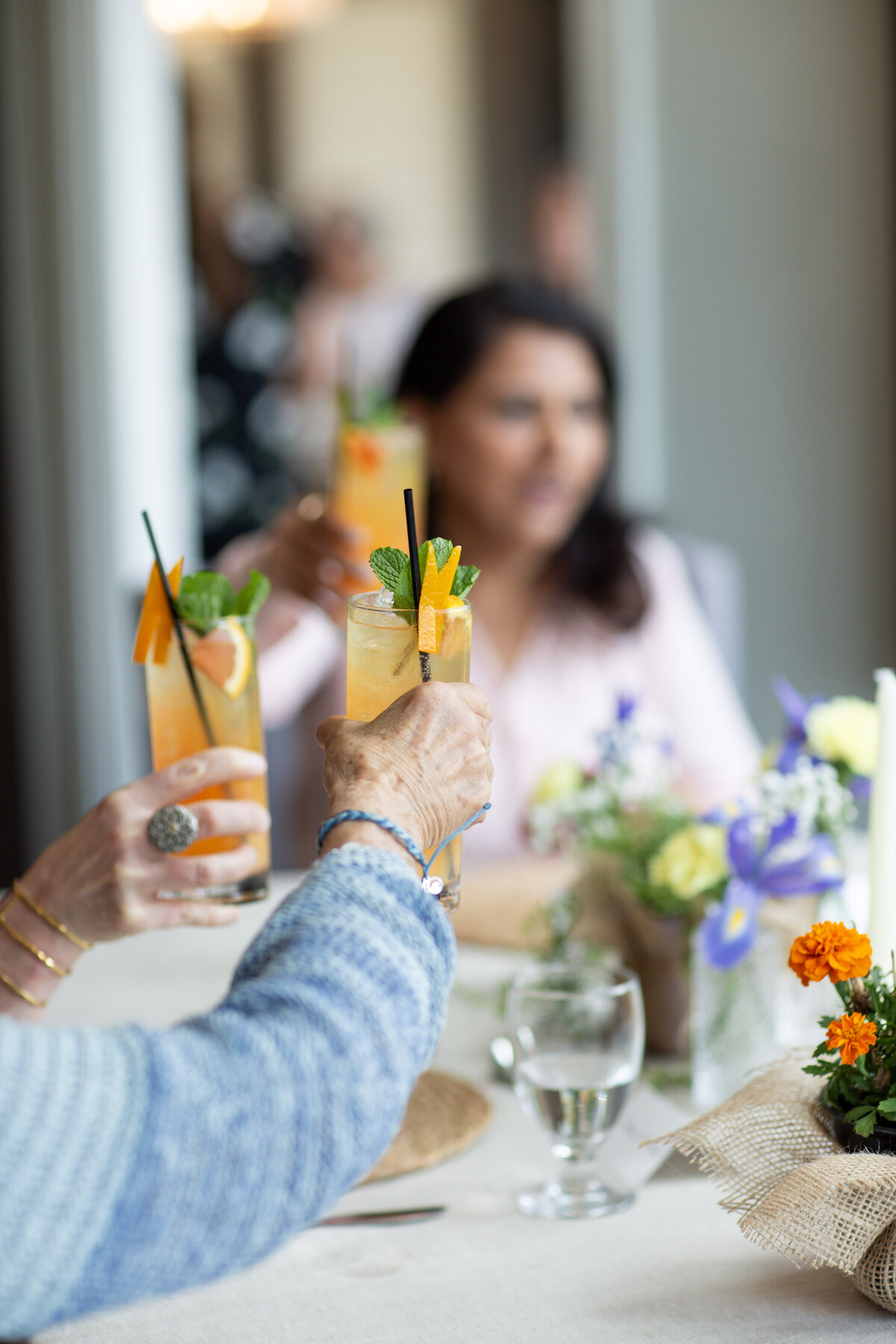 Guests raising fresh drinks together at The Healing Table